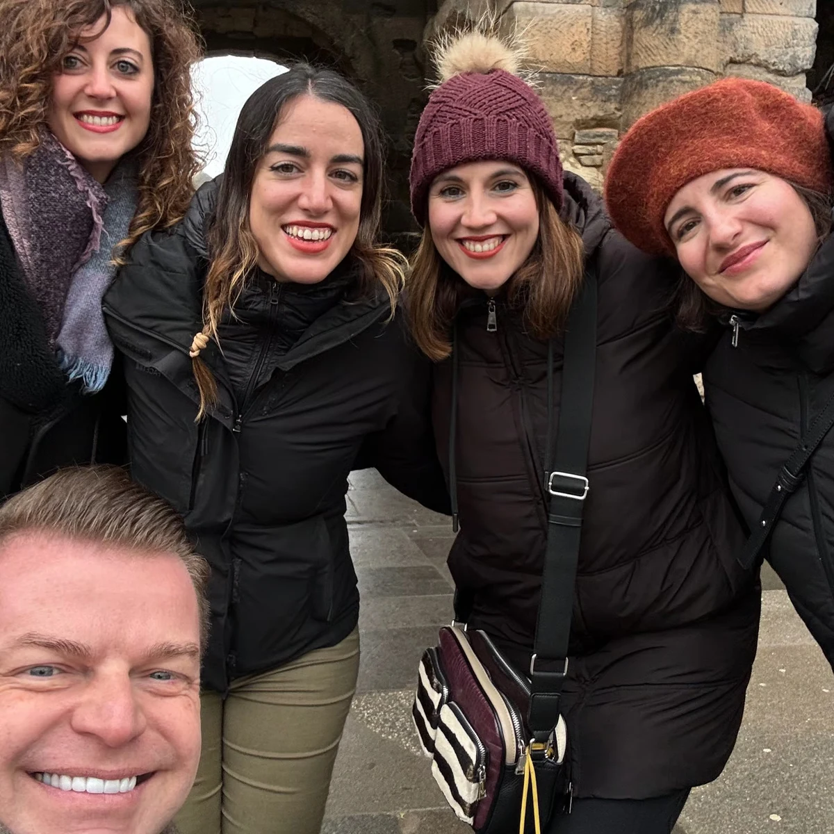 Private Luxembourg tour guests smiling with their guide beside castle walls