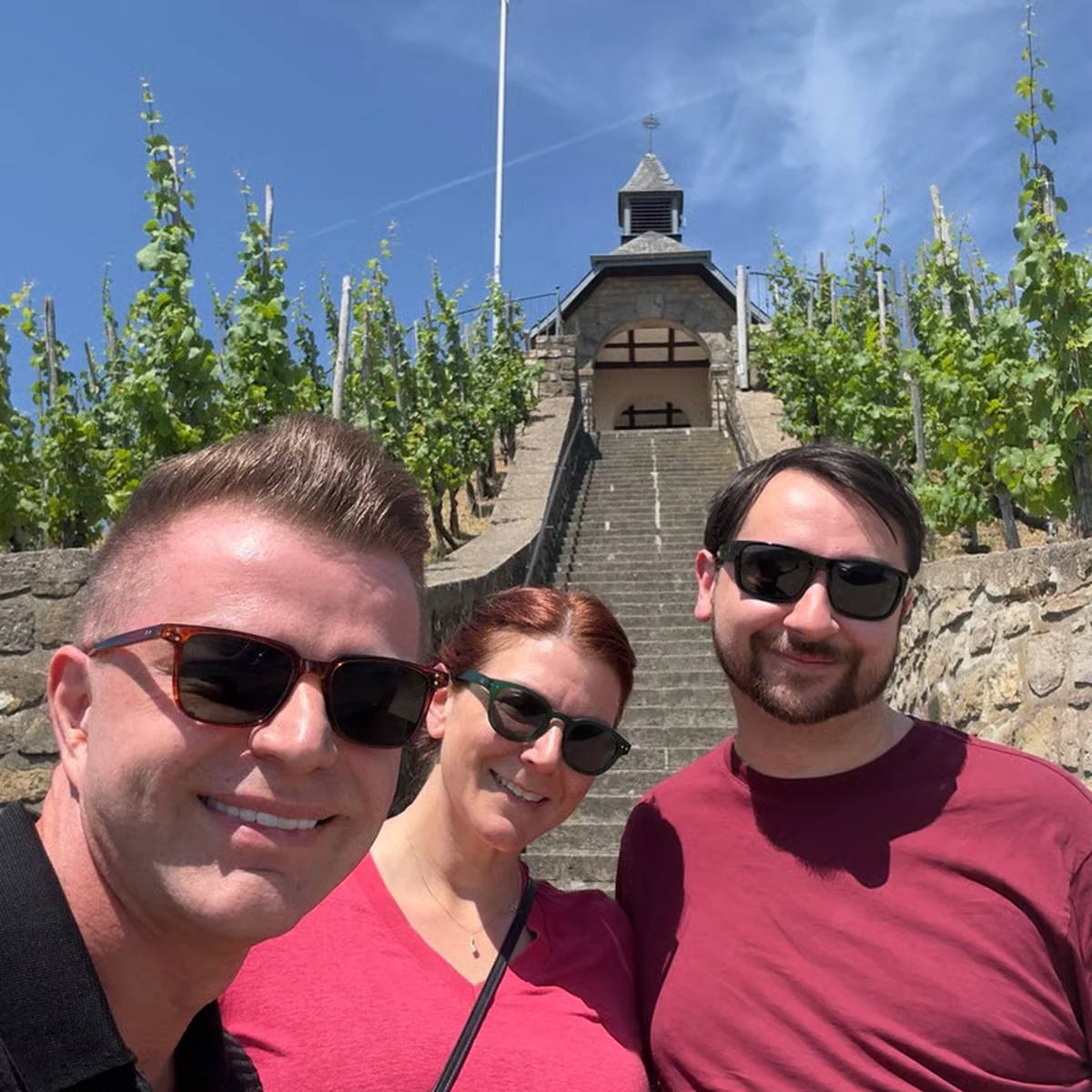 Private tour guests smiling in a Moselle vineyard