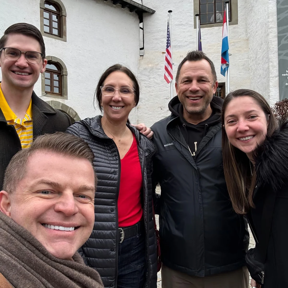 A family group with their guide outside a Luxembourg WWII museum