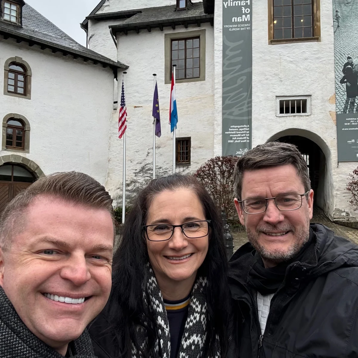 Guests and guide smiling outside a Luxembourg WWII museum
